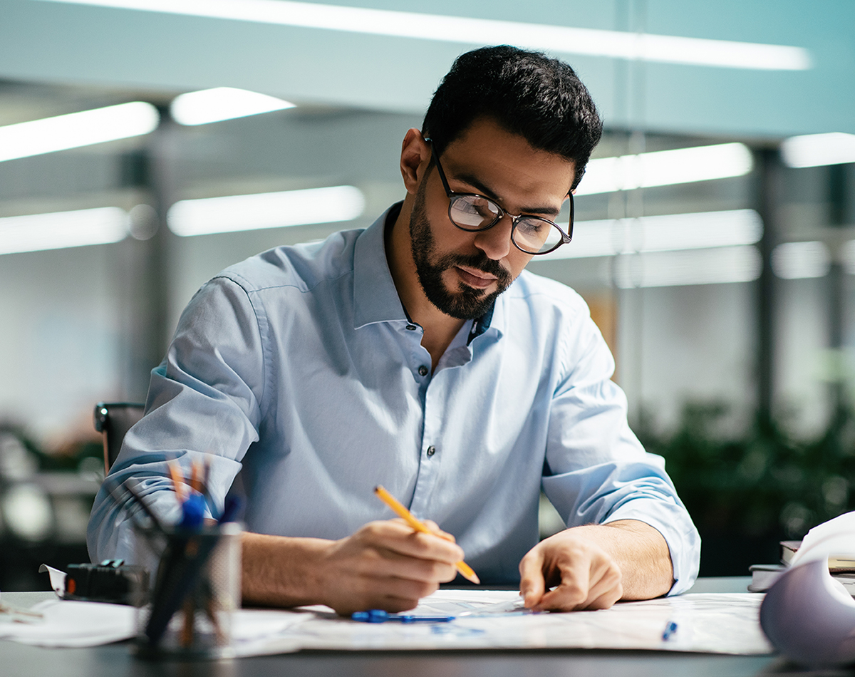 man in glasses with beard works with work in office