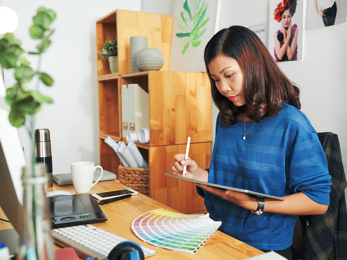 Designer working on color palette on graphics tablet